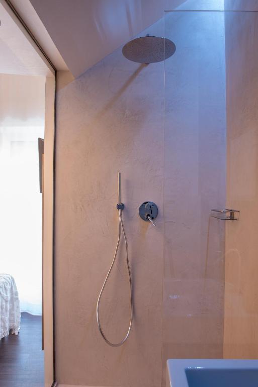 a bathroom with a shower with a glass door at Sinestesia in Polignano a Mare