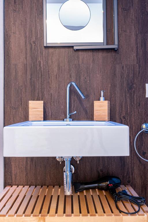 a bathroom with a white sink and a mirror at Sinestesia in Polignano a Mare
