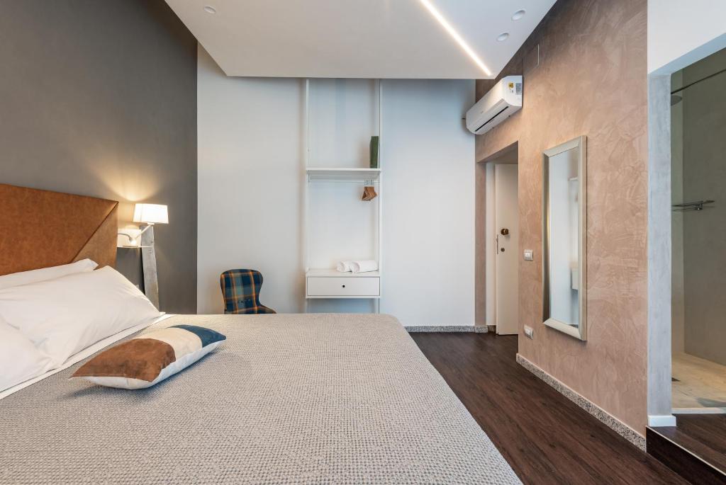a bedroom with a large bed with a white bedspread at Sinestesia in Polignano a Mare