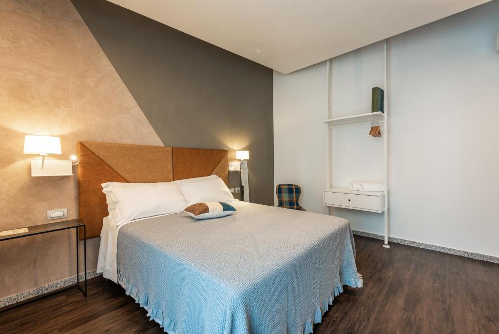 a bedroom with a bed with a teddy bear on it at Sinestesia in Polignano a Mare