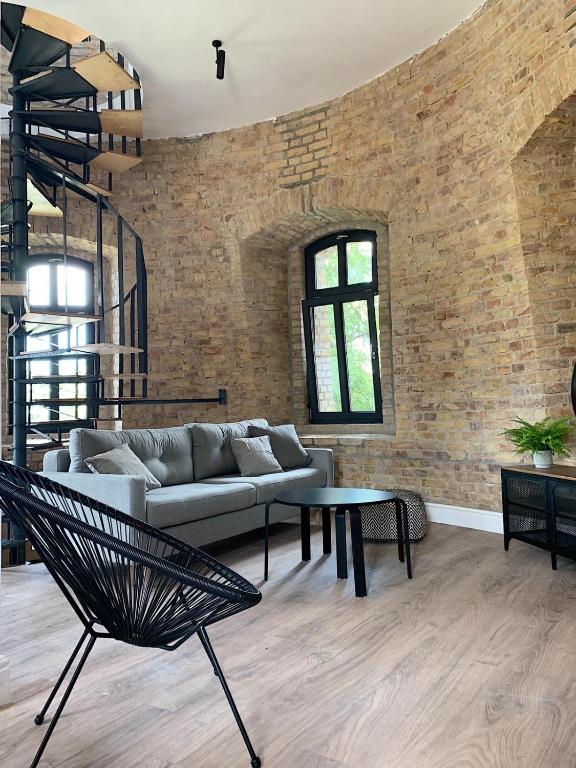 a living room with a couch and a table at Apartamenty Wieża - Tower Apartments in Wałcz