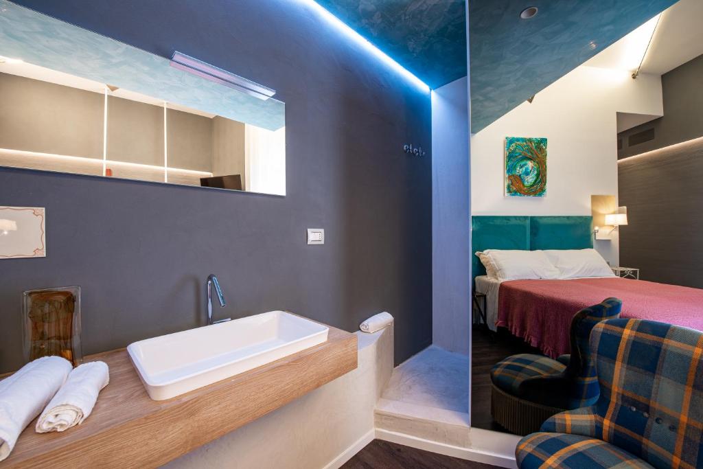 a bathroom with a sink and a bed at Sinestesia in Polignano a Mare