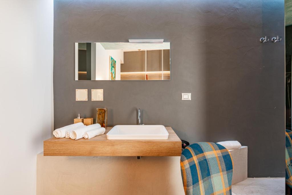 a bathroom with a sink and a mirror at Sinestesia in Polignano a Mare