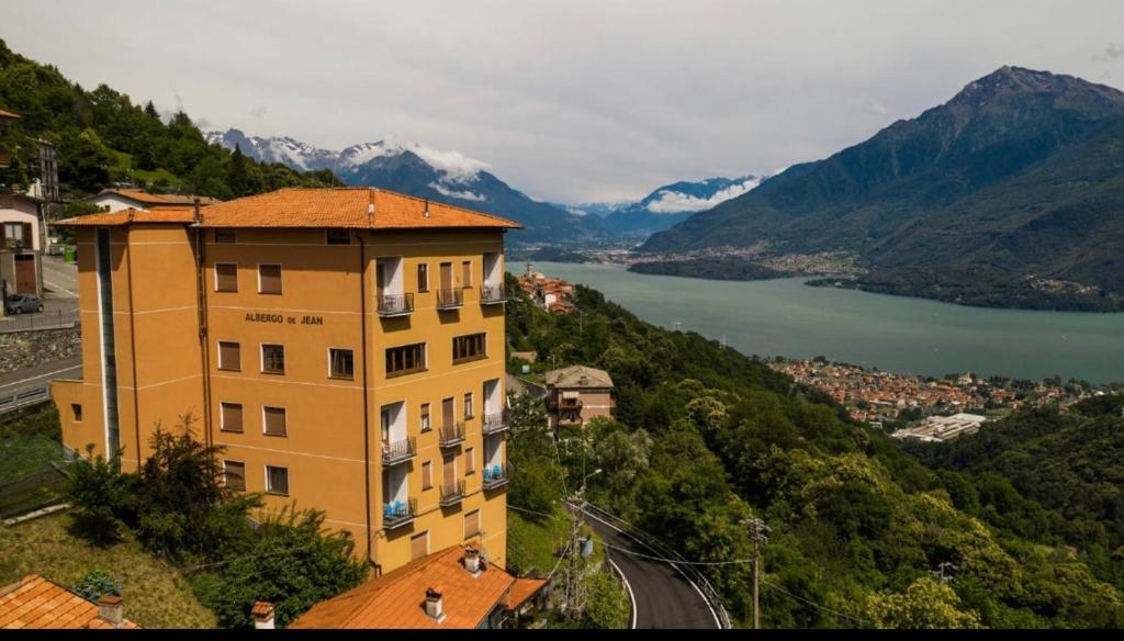 a building on the side of a mountain with a lake at Albergo De Jean in Garzeno