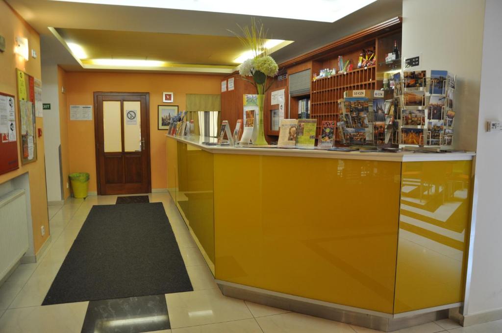 a lobby with a yellow counter in a store at City Central De Luxe in Prague