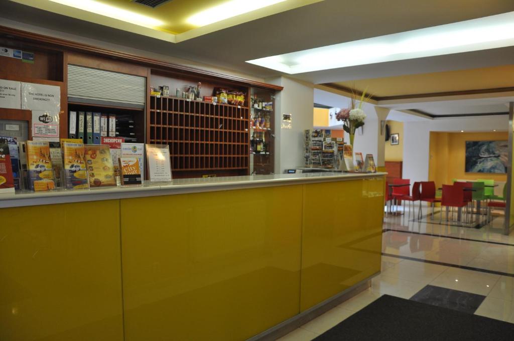 a restaurant with a yellow counter in a room at City Central De Luxe in Prague