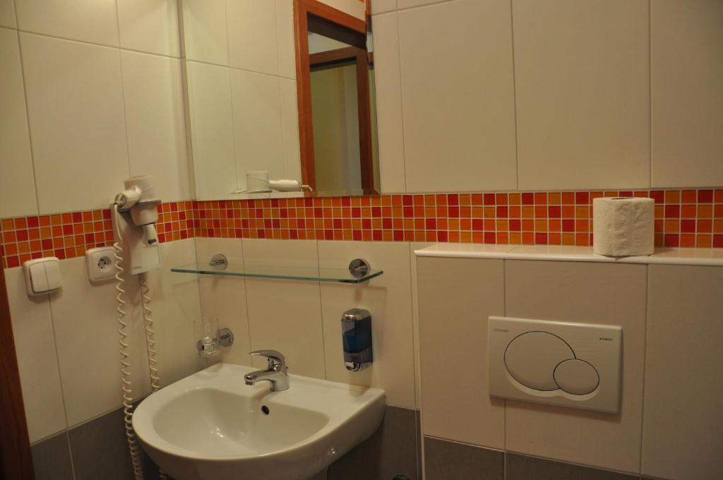 a bathroom with a sink and a mirror at City Central De Luxe in Prague