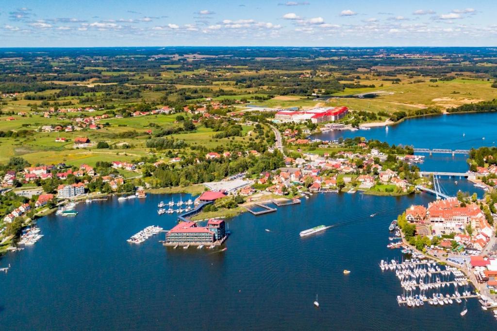 an aerial view of a harbor with boats in the water at Cicha Zatoka in Mikołajki