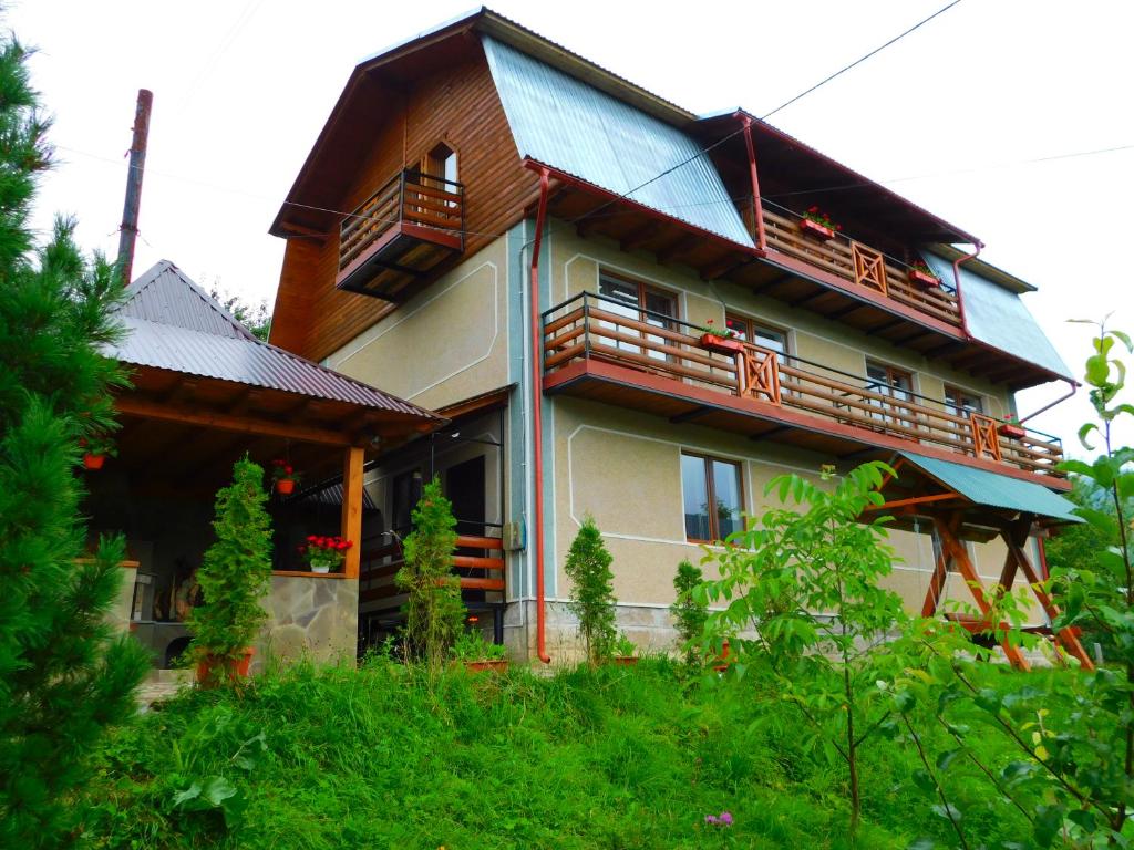 a large house with a balcony on the side of it at Glanz Cottage in Yaremche