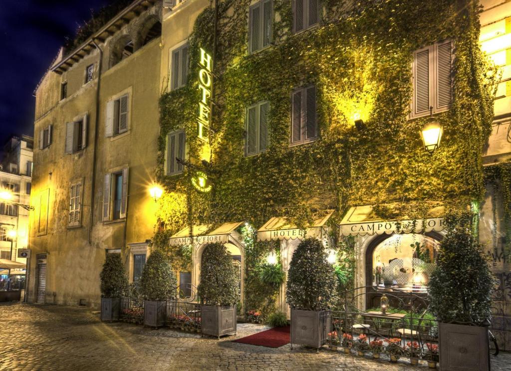 a building covered in ivy at night at Boutique Hotel Campo de' Fiori in Rome