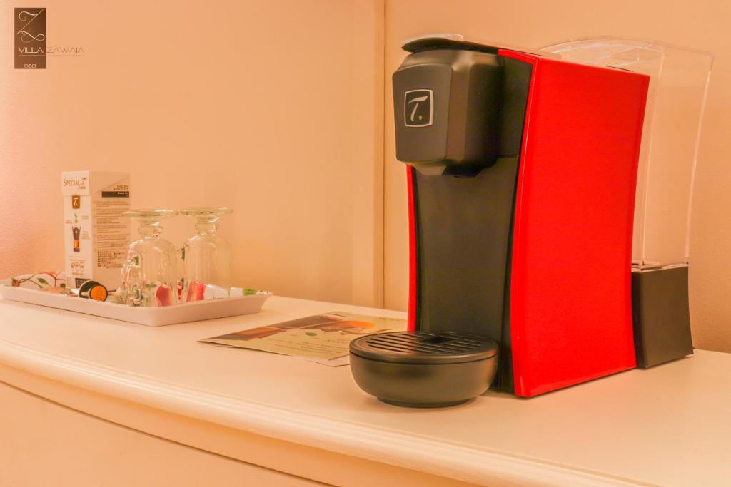 a red and black coffee maker sitting on a counter at Villa Zawaia B&B in Lagos