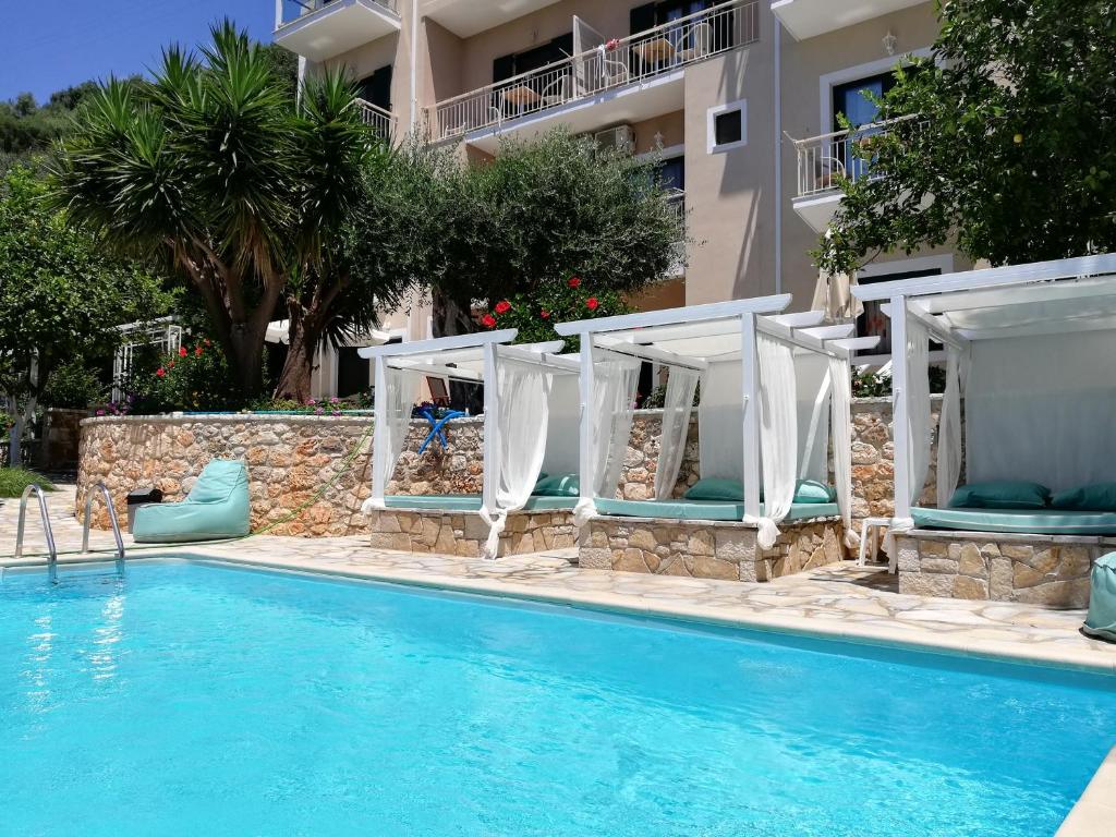 a resort with a swimming pool and a building at A Vista in Parga
