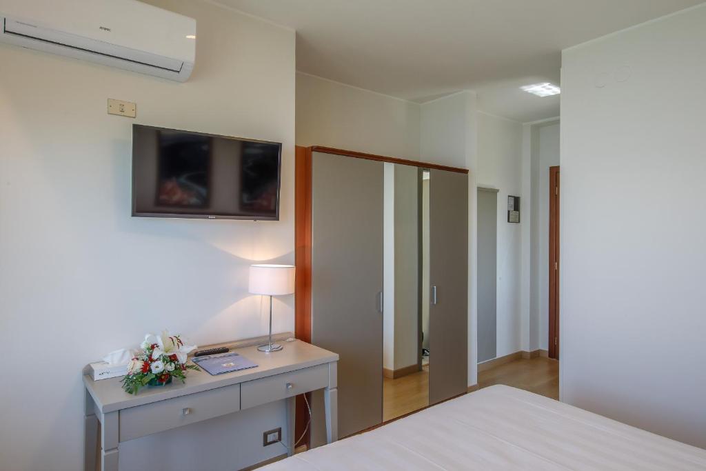 Postel nebo postele na pokoji v ubytování Hotel Lidò