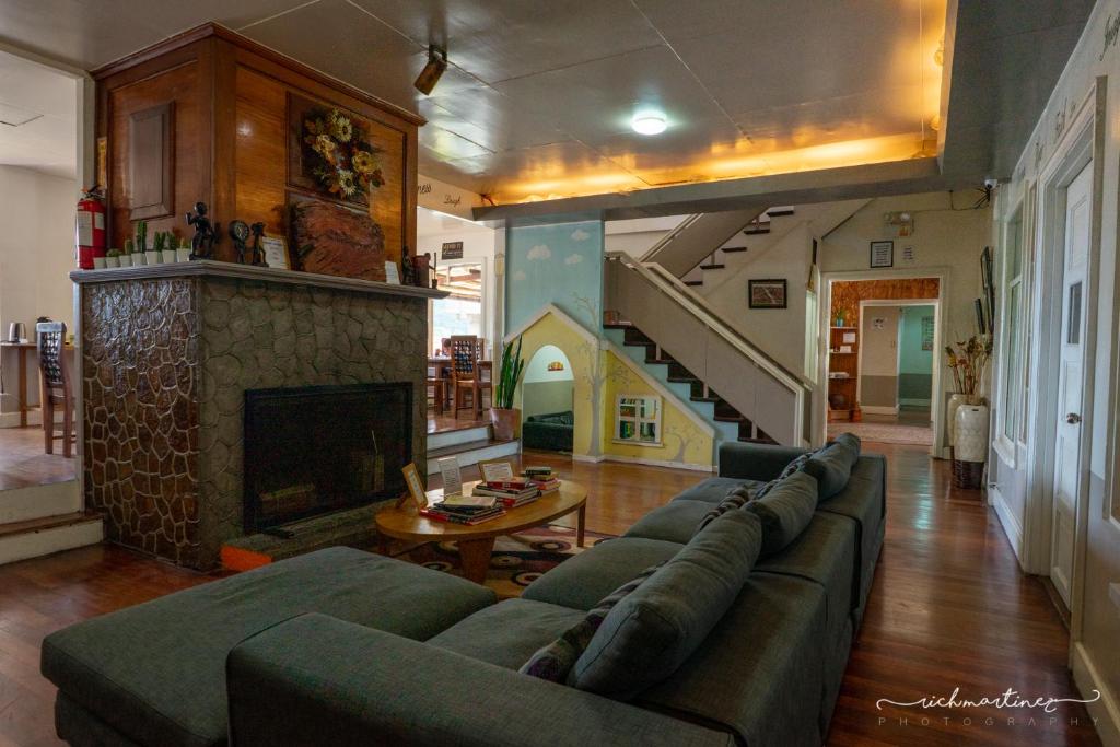 a living room with a couch and a fireplace at Old Orangewood Bed & Breakfast in Baguio