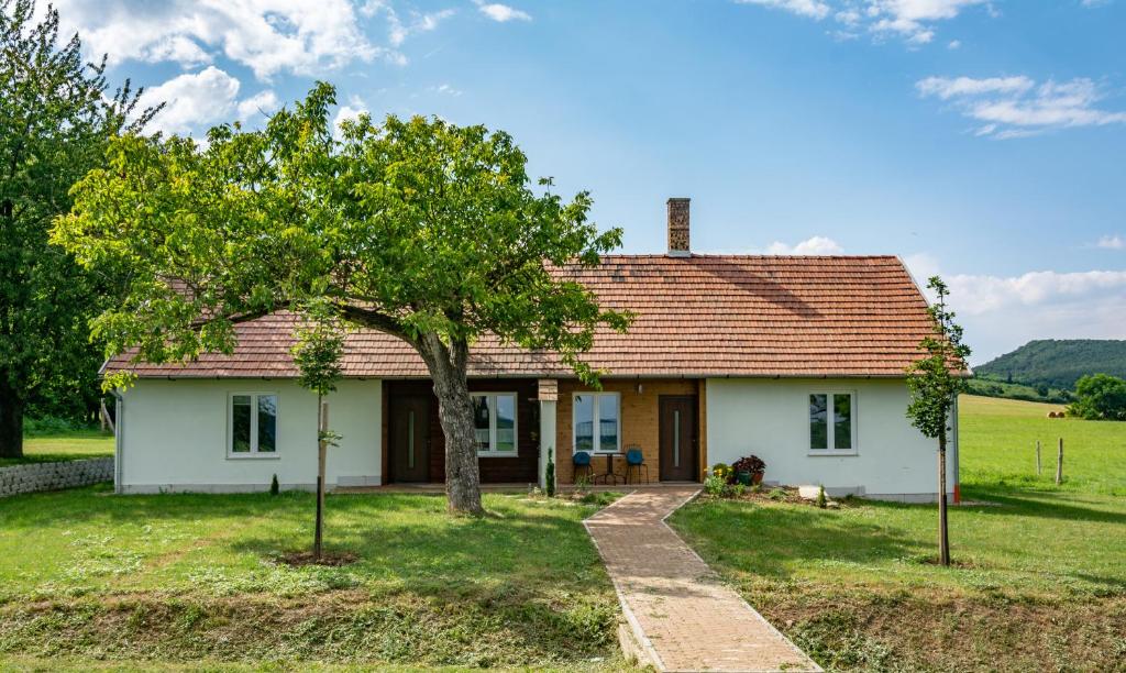 a small white house with a tree in front of it at House of the Golden Horse in Hosszúréti Lovas Major in Törökbálint