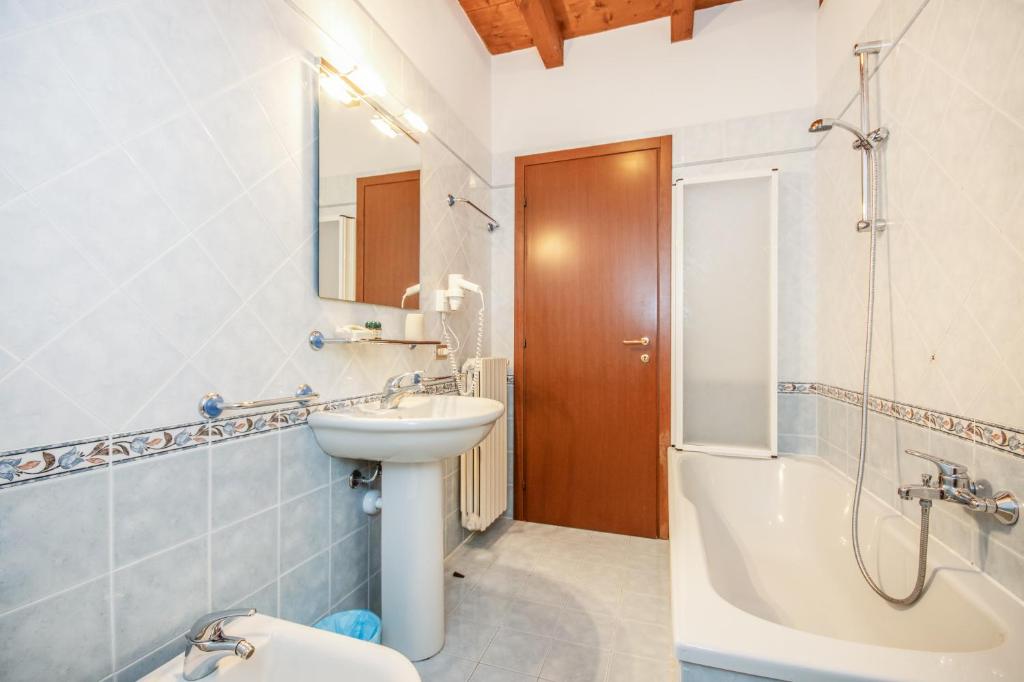 a bathroom with a sink and a shower and a toilet at Agriturismo La Filanda in Manerba del Garda