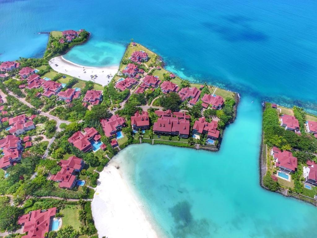 an aerial view of a island with pink condos at cocoon apartment in Victoria