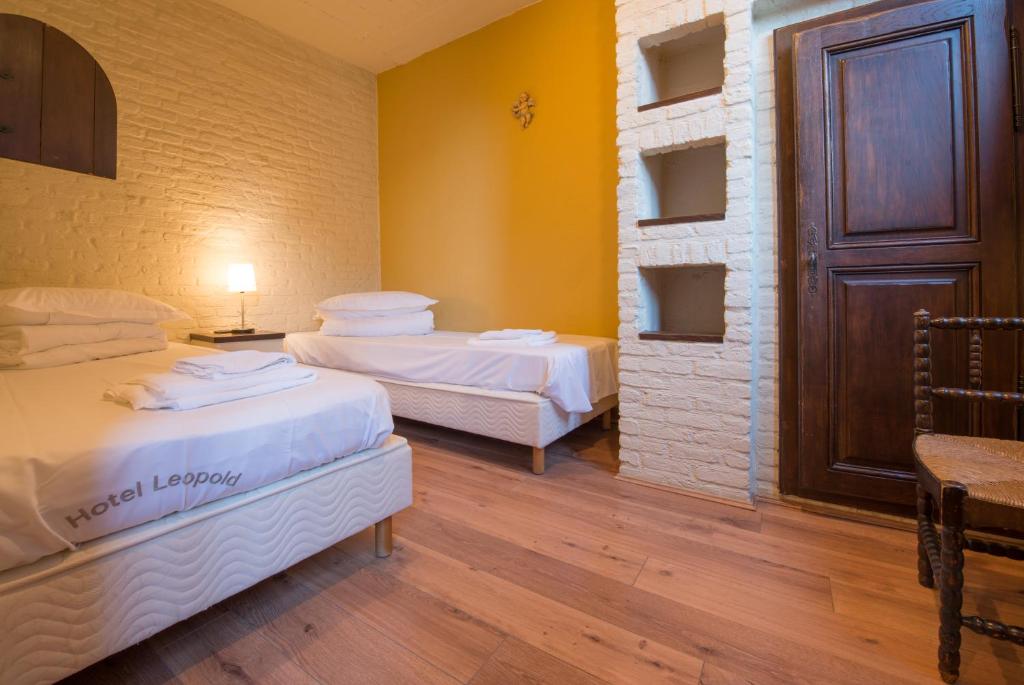 Postel nebo postele na pokoji v ubytování Hotel Leopold