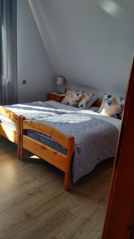 a bedroom with a large wooden bed in a room at Pokoje Gościnne Anna in Poronin