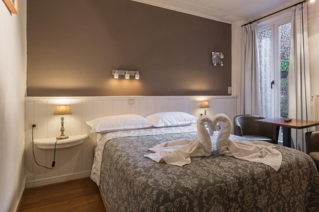 Postel nebo postele na pokoji v ubytování Hotel Leopold