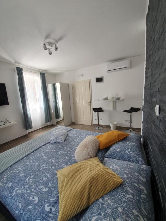 a bedroom with a large blue bed with two pillows at Apartments Borghetto in Vinkuran