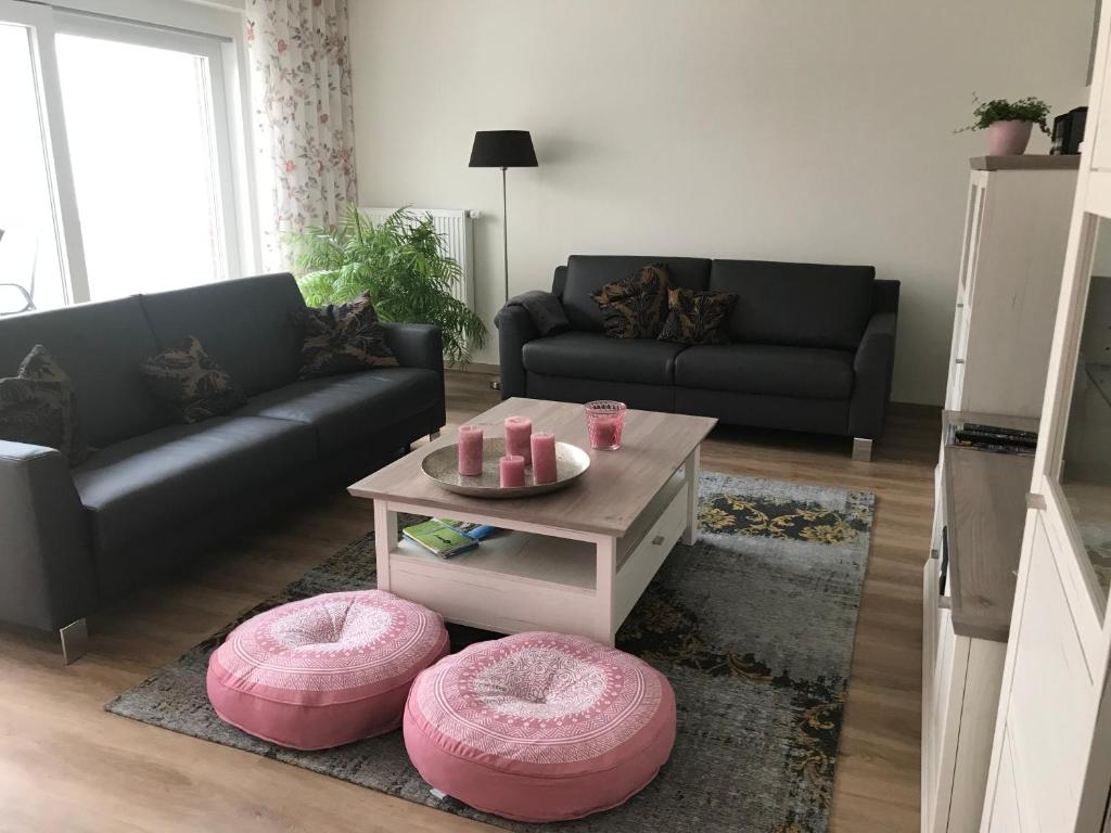 a living room with two couches and a coffee table at Ferienwohnung Am Haarhaus in Ostbevern