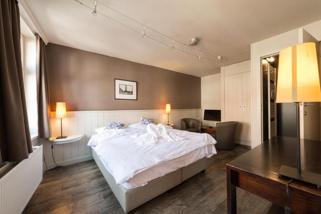 Postel nebo postele na pokoji v ubytování Hotel Leopold