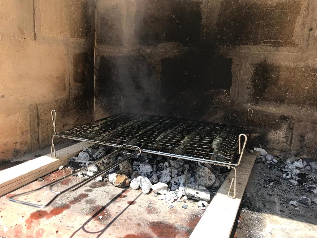 a grill in a room with rocks and ashes at Apartments Borghetto in Vinkuran