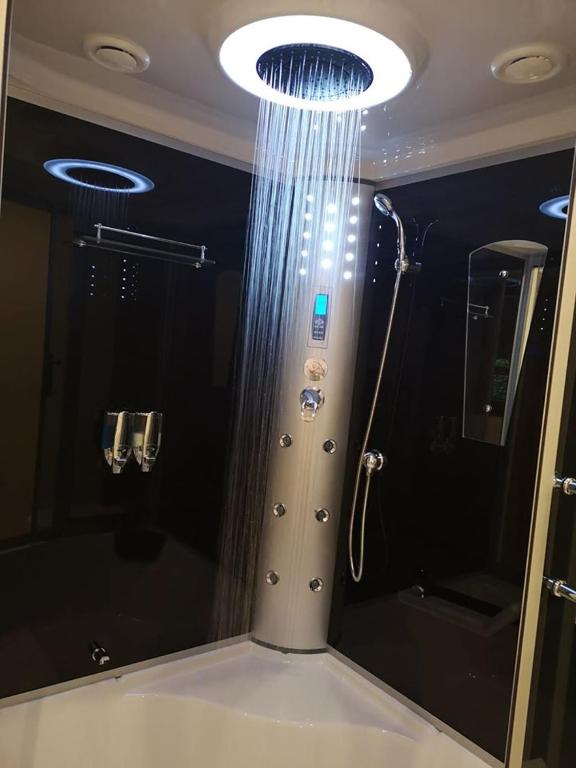 a bathroom with a shower and a large mirror at Willa Seba in Zakopane