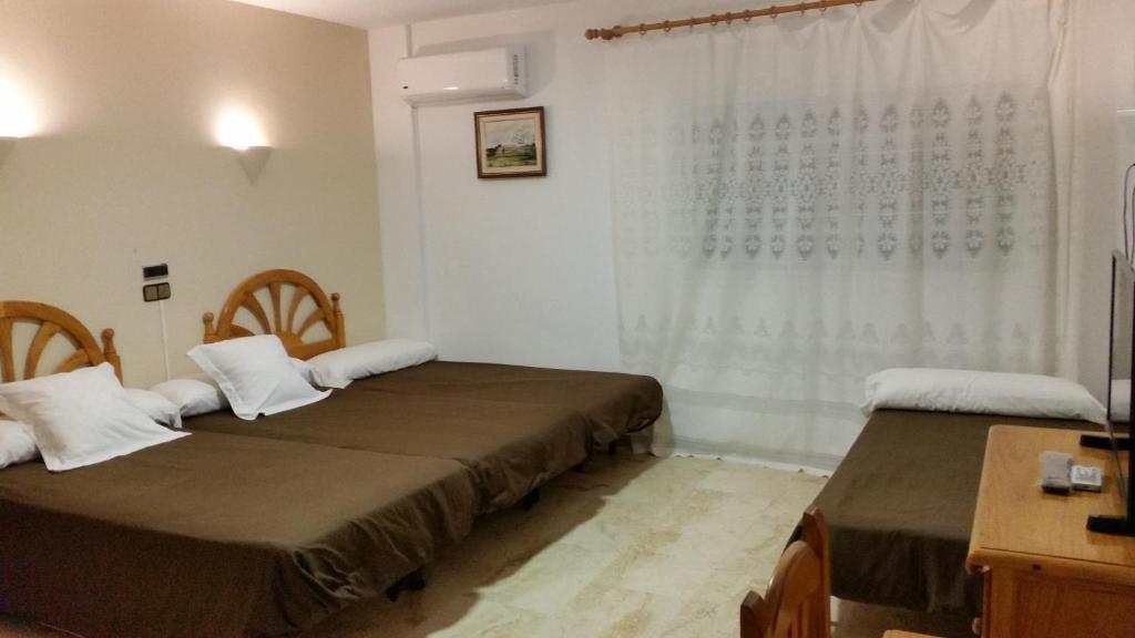 Postel nebo postele na pokoji v ubytování Hotel Balcón de Cazorla