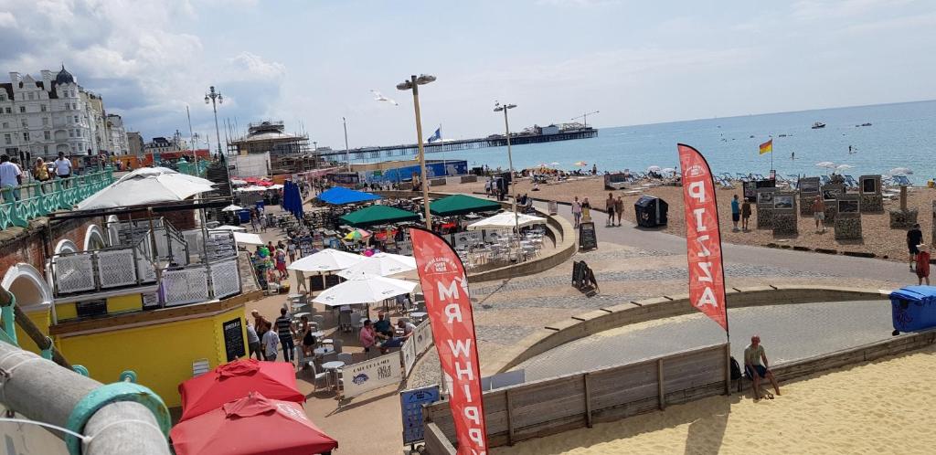a beach with umbrellas and a crowd of people at Andorra Guest Accommodation in Brighton & Hove