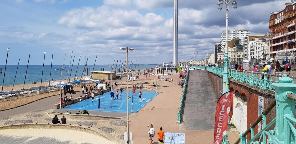 people walking on a pier near the beach at Andorra Guest Accommodation in Brighton & Hove