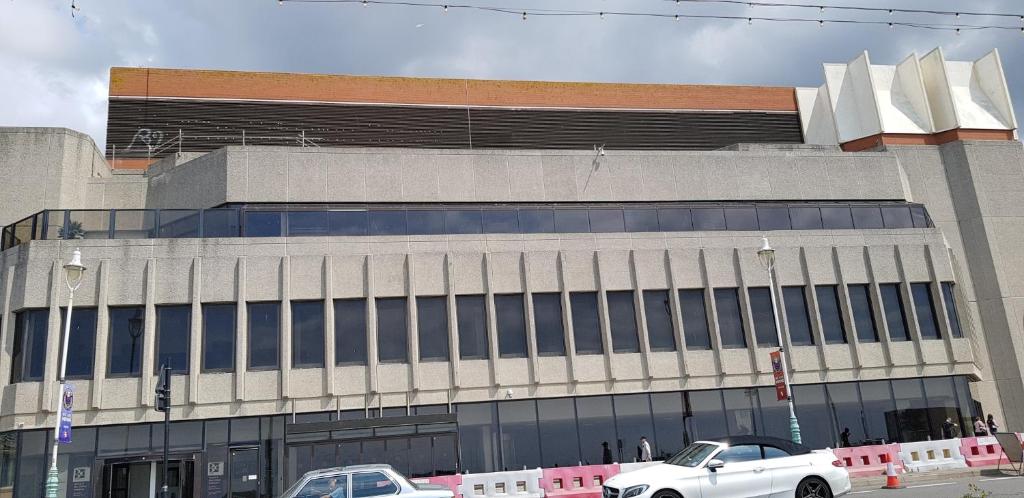a building with two cars parked in front of it at Andorra Guest Accommodation in Brighton & Hove