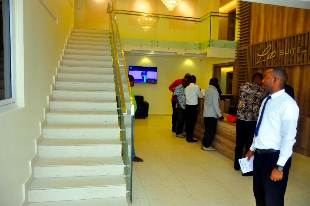 a group of people standing around a staircase in a building at Lit Suites in Abuja