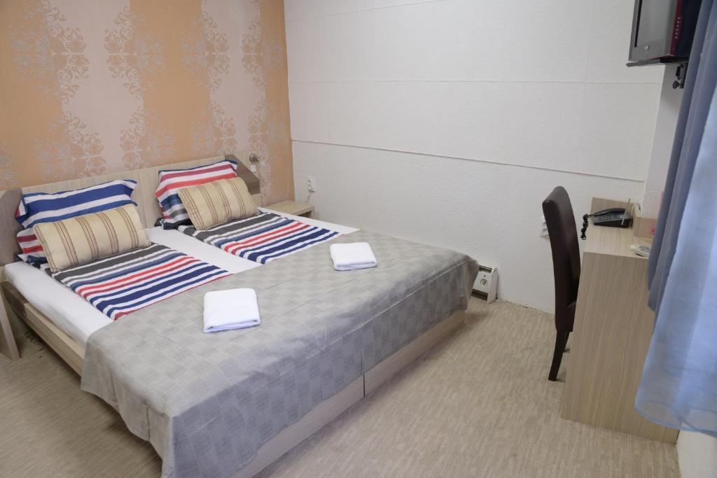 Postel nebo postele na pokoji v ubytování Guest House GOLDEN COIN