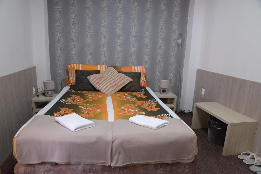 Postel nebo postele na pokoji v ubytování Guest House GOLDEN COIN