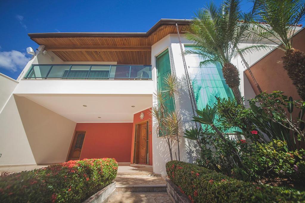 a house with a palm tree in front of it at Casa Bela Vista in Aparecida