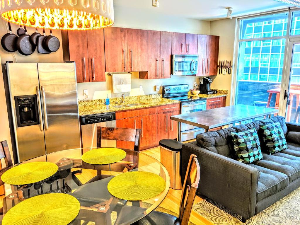 a kitchen with a couch and a table and chairs at Downtown Loft Oasis in Columbus