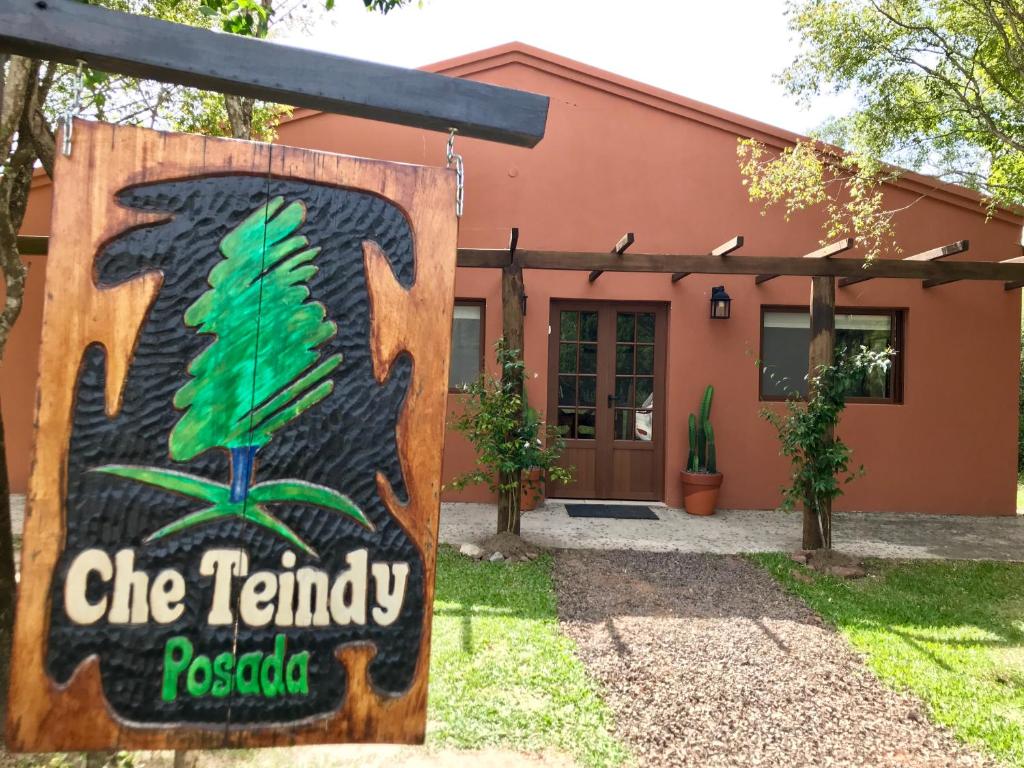 a building with a sign in front of it at Posada Che Teindy in Colonia Carlos Pellegrini