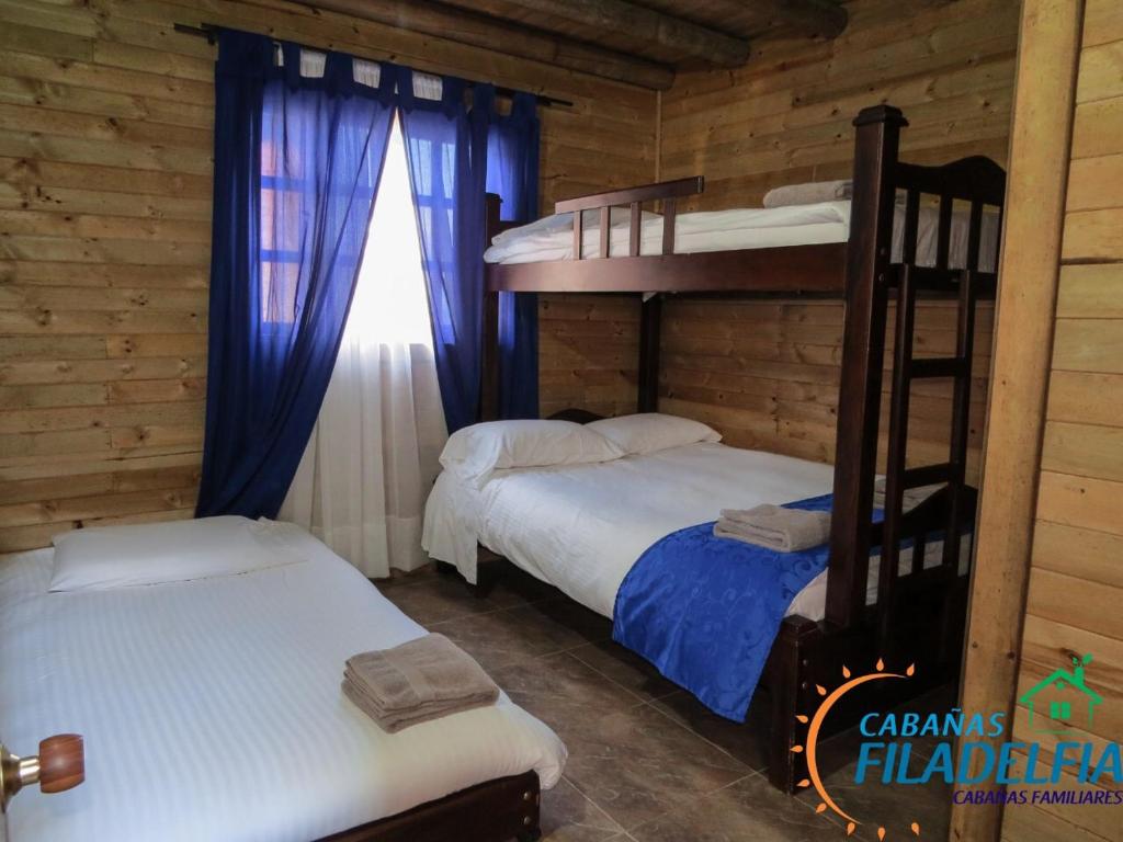 Cama o camas de una habitación en Cabañas Filadelfia