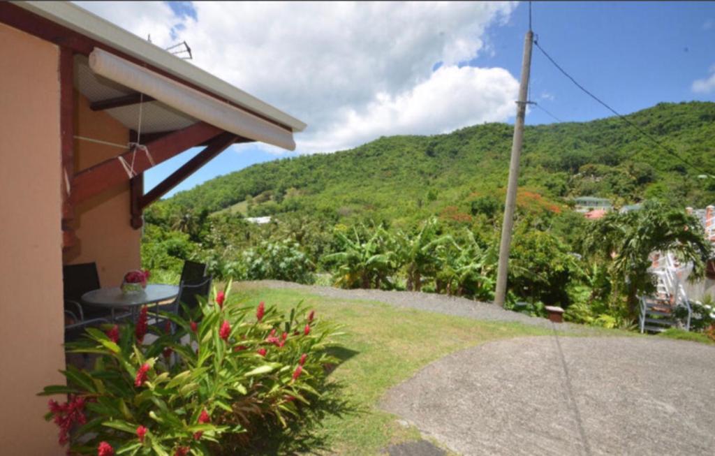 a house with a view of a mountain at Bougain Fleuri in Deshaies