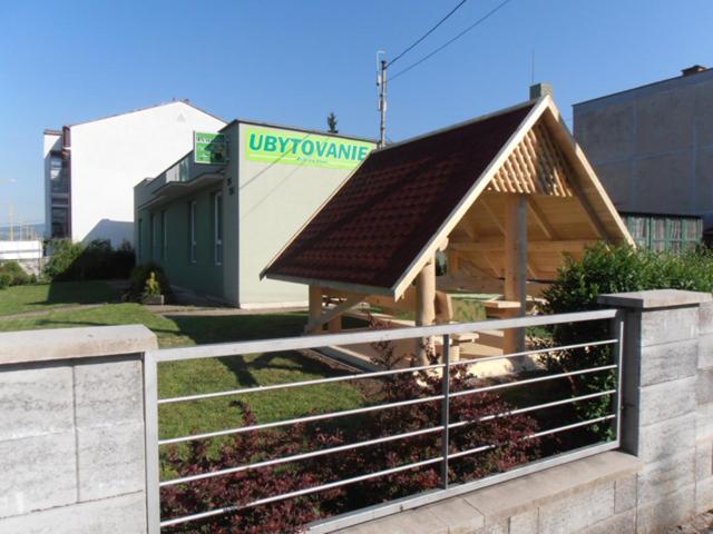 a building with a roof on top of a fence at Zelený Dom in Bojnice