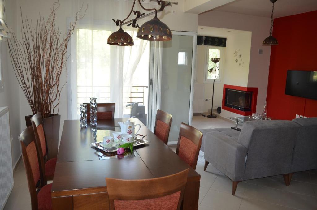 a living room with a dining room table and a couch at Holiday Lefkas Moonlight Luxury Appartments in Nikiana