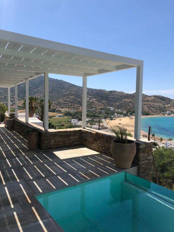 a house with a swimming pool and a pergola at Theros apartments 2 in Mylopotas