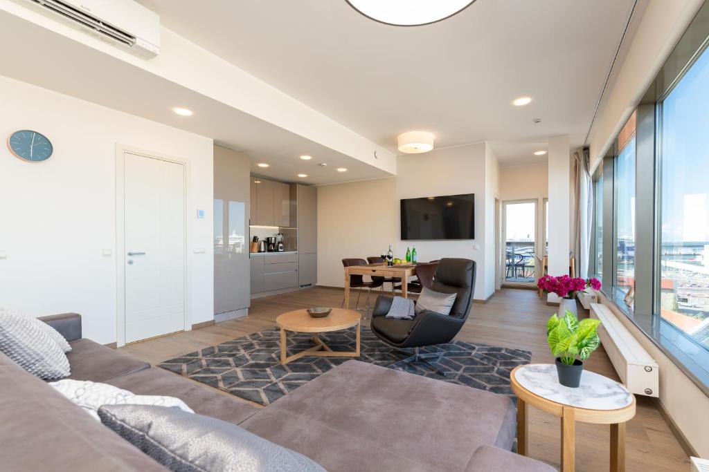 a living room with a couch and a table at Central Lootsi Penthouse in Tallinn