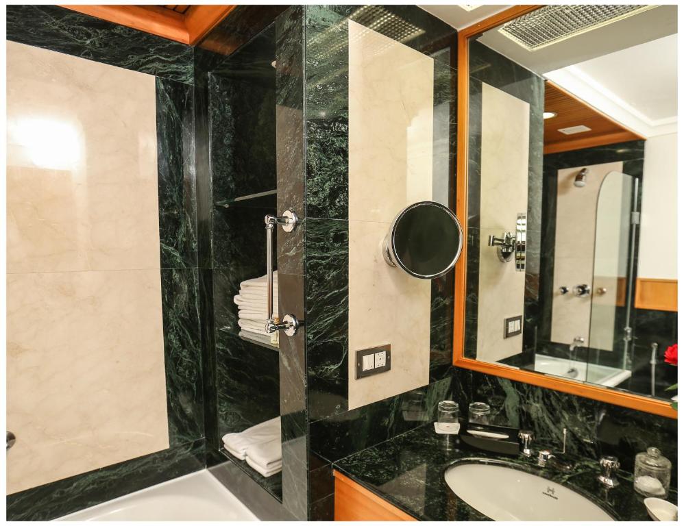 a bathroom with a sink and a mirror at Trident Chennai in Chennai
