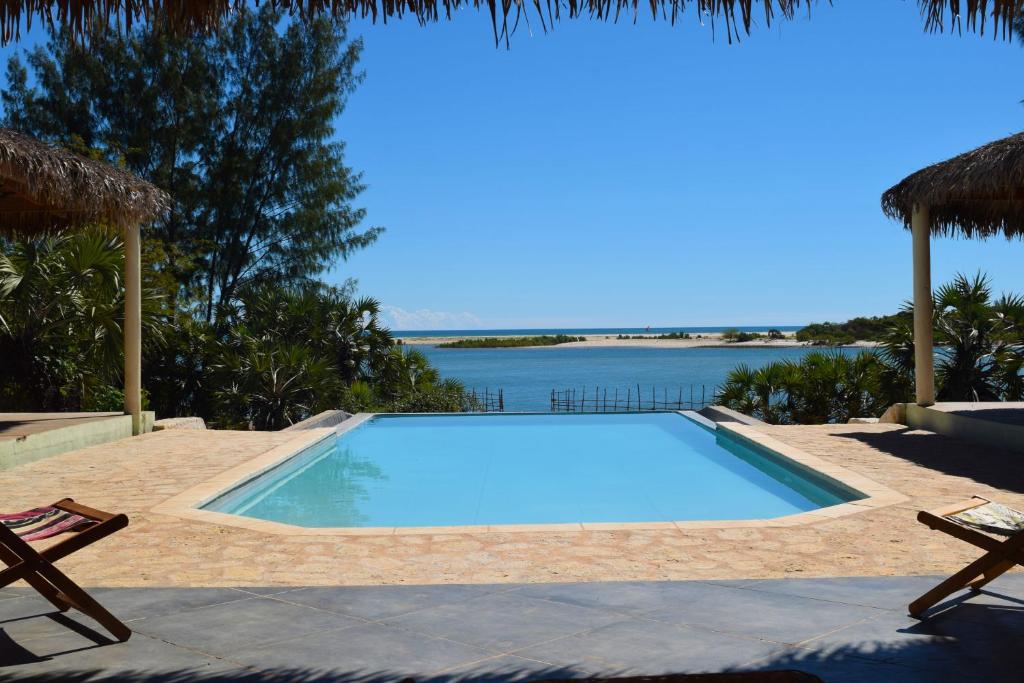 a swimming pool with a view of the water at Antsanitia - Domaine du Mandravasarotra in Antsianitia