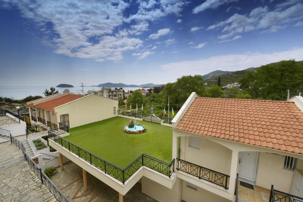 an aerial view of a house with a green yard at Amalia in Paleo Tsifliki
