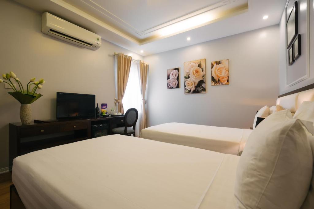 Postel nebo postele na pokoji v ubytování La Palm Hotel