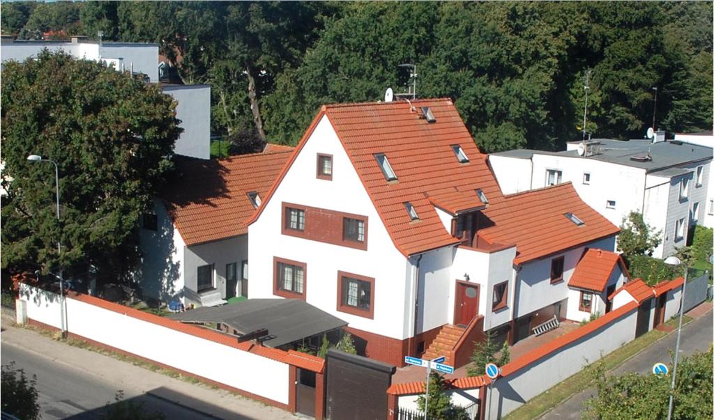 an overhead view of a white house with orange roofs at Hotelik Za Murem in Kołobrzeg